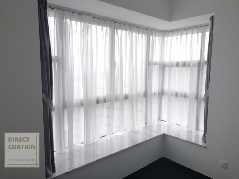 Grey dim-out night curtains and white day curtains in L-shaped windows